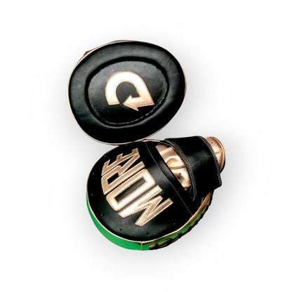 Black and gold boxing gloves with a brand logo on a white background