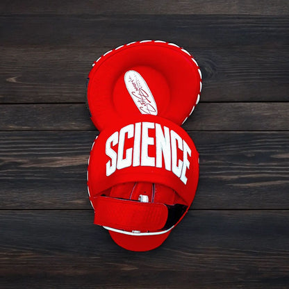 Red boxing glove with 'SCIENCE' text on a wooden background